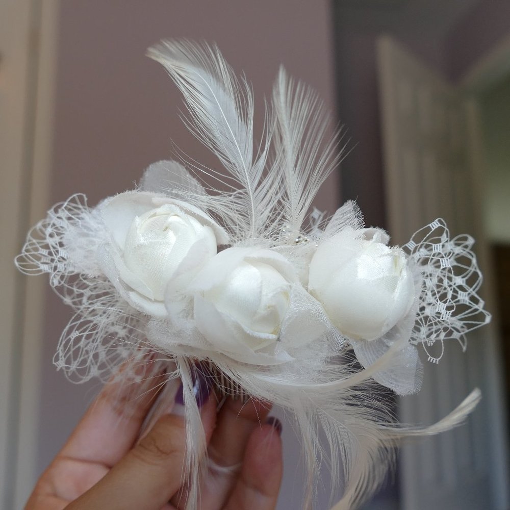 Rose, feather, and fishnet bridal hair piece